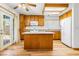 Full kitchen featuring wooden cabinets, island, stainless steel appliances, and ample counter space at 371 Cambray St, Henderson, NV 89074