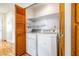 Convenient laundry room features a stacked washer and dryer set and ample storage space at 371 Cambray St, Henderson, NV 89074