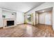 Spacious living room featuring a cozy fireplace, natural light, and hardwood floors at 371 Cambray St, Henderson, NV 89074