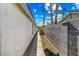 Narrow side yard with block wall and exterior home walls, leads to backyard at 371 Cambray St, Henderson, NV 89074
