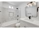 Modern bathroom featuring marble tile shower, and bright white cabinets and vanity at 3907 Torsby Pl, Las Vegas, NV 89119