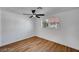 Bright bedroom features hardwood floors, a ceiling fan, and a window with natural light at 3907 Torsby Pl, Las Vegas, NV 89119
