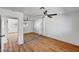 Spacious bedroom with hardwood floors, fan, and a sliding door closet with mirrored doors at 3907 Torsby Pl, Las Vegas, NV 89119