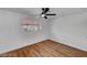 Bright bedroom features hardwood floors, a ceiling fan, and a window with natural lighting at 3907 Torsby Pl, Las Vegas, NV 89119