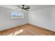 Light-filled bedroom with a ceiling fan, and hardwood floors at 3907 Torsby Pl, Las Vegas, NV 89119