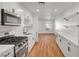 Modern kitchen featuring white cabinets, stainless steel appliances, and a gas range at 3907 Torsby Pl, Las Vegas, NV 89119