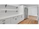 Bright kitchen featuring modern cabinets, open shelving, and stainless steel refrigerator at 3907 Torsby Pl, Las Vegas, NV 89119