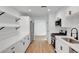 Bright, modern kitchen features stainless steel appliances, white cabinetry, and hardwood floors at 3907 Torsby Pl, Las Vegas, NV 89119