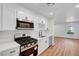 Well-equipped kitchen featuring modern appliances, white cabinets, and an open layout at 3907 Torsby Pl, Las Vegas, NV 89119