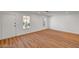 Bright, spacious living room with hardwood floors and natural light from two windows at 3907 Torsby Pl, Las Vegas, NV 89119