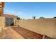 Private patio with tile flooring, secure fencing, and an access gate for added security at 3907 Torsby Pl, Las Vegas, NV 89119
