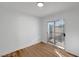 Bright room features sliding glass doors to the patio, and modern white walls and wood-look floors at 3907 Torsby Pl, Las Vegas, NV 89119