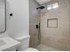 Modern tiled shower featuring neutral tile, rainfall shower head, and niche storage at 3907 Torsby Pl, Las Vegas, NV 89119