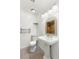 Bright bathroom featuring a pedestal sink, decorative mirror, and modern fixtures at 5043 Spencer St # A, Las Vegas, NV 89119