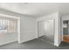 Comfortable bedroom featuring neutral carpet, mirrored closet doors, and ample natural light at 5043 Spencer St # A, Las Vegas, NV 89119
