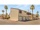 Inviting townhome complex featuring private garages and well-maintained exteriors surrounded by palm trees at 5043 Spencer St # A, Las Vegas, NV 89119