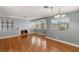Well-lit living room showcasing fireplace, hardwood floors, a window view, and space for entertaining at 5043 Spencer St # A, Las Vegas, NV 89119