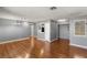 Open-concept living area with wood floors connecting the kitchen with a half-wall and a well-lit room entrance at 5043 Spencer St # A, Las Vegas, NV 89119