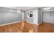 Open-concept living room with hardwood floors, neutral paint, and a breakfast bar leading to the kitchen at 5043 Spencer St # A, Las Vegas, NV 89119