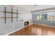 Bright living room featuring wood floors, fireplace, and large windows for natural light and a welcoming atmosphere at 5043 Spencer St # A, Las Vegas, NV 89119