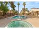 Community pool area, featuring a hot tub and towering palm trees at 5043 Spencer St # A, Las Vegas, NV 89119
