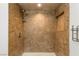 Tile shower featuring shower head and built-in shelving at 5043 Spencer St # A, Las Vegas, NV 89119