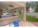 View of outdoor covered patio with built-in grill and landscaped backyard offering space for entertaining at 5228 Giallo Vista Ct, North Las Vegas, NV 89031