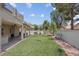 Spacious backyard featuring an artificial lawn, covered patio, and basketball hoop perfect for outdoor activities at 5228 Giallo Vista Ct, North Las Vegas, NV 89031