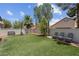 Artificial grass backyard with basketball court, bench, and seating area, perfect for relaxation and recreation at 5228 Giallo Vista Ct, North Las Vegas, NV 89031