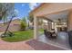Beautiful backyard with green turf, covered patio, outdoor kitchen, and a basketball court at 5228 Giallo Vista Ct, North Las Vegas, NV 89031