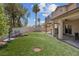Lush backyard featuring an outdoor kitchen, a covered patio, and well-kept turf at 5228 Giallo Vista Ct, North Las Vegas, NV 89031