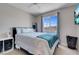 Cozy bedroom with a large window view, a ceiling fan, and neutral walls at 5228 Giallo Vista Ct, North Las Vegas, NV 89031