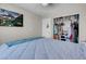Bright bedroom featuring a spacious closet, a ceiling fan, and a wall-mounted TV at 5228 Giallo Vista Ct, North Las Vegas, NV 89031