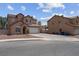 Two-story house with desert landscaping featuring neutral tones and an attached two-car garage at 5228 Giallo Vista Ct, North Las Vegas, NV 89031