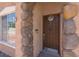 Inviting entryway with decorative stonework accents around the front door and nearby window at 5228 Giallo Vista Ct, North Las Vegas, NV 89031