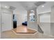 Hallway with wood and carpet flooring leads into the living room with natural light at 5228 Giallo Vista Ct, North Las Vegas, NV 89031