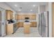Modern kitchen features stainless steel appliances and oak cabinets, and center island at 5228 Giallo Vista Ct, North Las Vegas, NV 89031