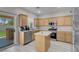 Bright kitchen with stainless steel appliances, oak cabinets, and view to the backyard at 5228 Giallo Vista Ct, North Las Vegas, NV 89031