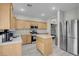 Well-lit kitchen featuring stainless steel appliances, wooden cabinets, and a functional island for added workspace at 5228 Giallo Vista Ct, North Las Vegas, NV 89031