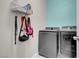 Laundry room featuring modern washer and dryer, plus metal shelving and utility storage at 5228 Giallo Vista Ct, North Las Vegas, NV 89031