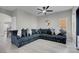 Bright living room with a large sectional couch and neutral walls, flooded with natural light at 5228 Giallo Vista Ct, North Las Vegas, NV 89031