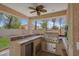 Outdoor kitchen with built-in grill, countertop, mini-fridge, and exterior lighting at 5228 Giallo Vista Ct, North Las Vegas, NV 89031