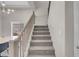 Carpeted staircase with light wood railings and a view of the dining area below at 5228 Giallo Vista Ct, North Las Vegas, NV 89031