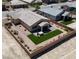 Aerial view of a single-story home featuring a well-manicured backyard with artificial turf and desert landscaping at 5528 Eleganza Ave, Pahrump, NV 89061