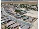 Aerial view of a suburban neighborhood featuring beige homes, desert landscaping, and roadways at 5528 Eleganza Ave, Pahrump, NV 89061