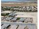 Aerial view of a suburban neighborhood with beige homes, desert landscaping, and expansive, vacant lots at 5528 Eleganza Ave, Pahrump, NV 89061