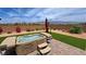 Backyard showcasing a relaxing hot tub area with lush greenery, beautiful desert landscaping, and mountain views at 5528 Eleganza Ave, Pahrump, NV 89061