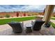Cozy backyard seating area with a patio, artificial turf, and desert landscaping at 5528 Eleganza Ave, Pahrump, NV 89061