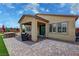 Backyard showcasing covered patio, spa, outdoor seating, and artifical turf at 5528 Eleganza Ave, Pahrump, NV 89061