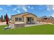 Backyard featuring covered patio, outdoor seating, spa, and artificial turf at 5528 Eleganza Ave, Pahrump, NV 89061